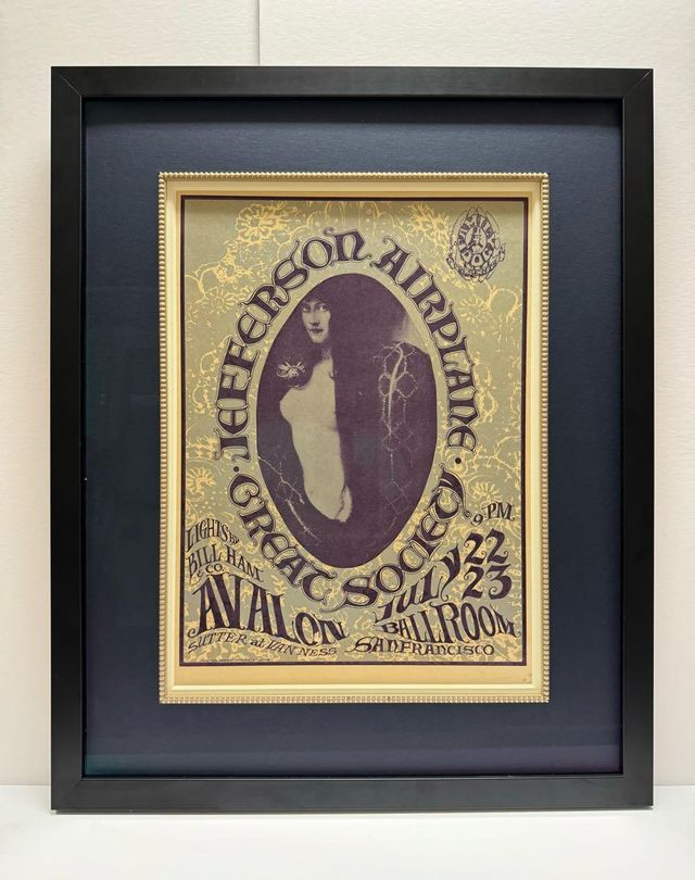 A vintage Jefferson Airplane and Great Society Avalon Ballroom poster set inside a gold inner frame on a dark mat, in a black frame